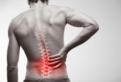 Stock image of a person holding their back in pain